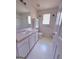 Bright bathroom with a white vanity, toilet, shower, and cabinet at 1130 Ivey Ln, Mcdonough, GA 30253