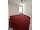 This bedroom has red carpets, a window, and ceiling fan at 1130 Ivey Ln, Mcdonough, GA 30253