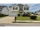 Inviting two-story home with a well-maintained lawn, attached garage, and neat landscaping at 1130 Ivey Ln, Mcdonough, GA 30253
