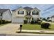 Attractive two-story home featuring a well-manicured lawn, attached garage, and tidy landscaping at 1130 Ivey Ln, Mcdonough, GA 30253
