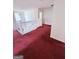 Upper-level hallway area with double doors, white trim, red carpet, and chandelier view at 1130 Ivey Ln, Mcdonough, GA 30253