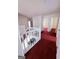 The hallway is carpeted and has a white banister at 1130 Ivey Ln, Mcdonough, GA 30253