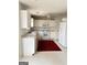 Well-lit kitchen with white cabinets, appliances, and a neutral countertop at 1130 Ivey Ln, Mcdonough, GA 30253