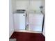 A small laundry room features a white washer and dryer at 1130 Ivey Ln, Mcdonough, GA 30253