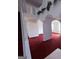 A pretty living area has arches, plants, and red carpets at 1130 Ivey Ln, Mcdonough, GA 30253