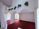 Bright living room with red carpet, decorative plants, and arched entryways for a spacious feel at 1130 Ivey Ln, Mcdonough, GA 30253