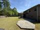 Large backyard with patio and green grass, enclosed by a wooden fence at 960 Spanish Moss Trl, Loganville, GA 30052