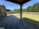 A spacious backyard featuring a wood fence, a concrete patio, and a manicured lawn for outdoor enjoyment at 960 Spanish Moss Trl, Loganville, GA 30052