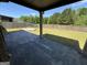 A covered porch leads to the fenced backyard with a concrete patio at 960 Spanish Moss Trl, Loganville, GA 30052