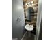 Stylish half bathroom featuring a unique wood accent wall, a modern vessel sink, and updated fixtures at 960 Spanish Moss Trl, Loganville, GA 30052