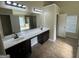 This luxurious bathroom includes dual sinks, granite counters, and a tiled shower at 960 Spanish Moss Trl, Loganville, GA 30052