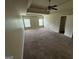 This large bedroom features a tray ceiling, ceiling fan, and 2 large windows at 960 Spanish Moss Trl, Loganville, GA 30052