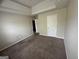 A neutral bedroom features a tray ceiling, brown carpet, and white trim at 960 Spanish Moss Trl, Loganville, GA 30052
