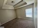 The bedroom has a large window with blinds, brown carpet, and neutral colored walls at 960 Spanish Moss Trl, Loganville, GA 30052