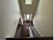 High angle view of the foyer with hardwood flooring, a staircase, and a front door with sidelights at 960 Spanish Moss Trl, Loganville, GA 30052