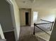 Upstairs hallway with carpet and railing, open doorways to bedrooms at 960 Spanish Moss Trl, Loganville, GA 30052