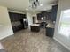 Modern kitchen with dark cabinetry, stainless steel appliances, granite countertops, and an island at 960 Spanish Moss Trl, Loganville, GA 30052