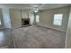 Large living room with multiple windows, a stone fireplace, and mixed flooring at 960 Spanish Moss Trl, Loganville, GA 30052