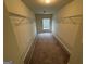 This walk-in closet has carpet, shelves, and a window at 960 Spanish Moss Trl, Loganville, GA 30052