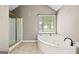 Bright bathroom features a separate shower and tub at 542 Creek Stone Ln, Stone Mountain, GA 30087