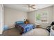 Bright bedroom with ceiling fan, natural light from the window, and carpet, creating a comfortable space at 542 Creek Stone Ln, Stone Mountain, GA 30087