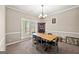 Traditional dining room with natural light, carpeting and classic decor at 542 Creek Stone Ln, Stone Mountain, GA 30087