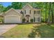 Charming two-story home featuring a well-maintained lawn, two-car garage, and traditional architectural details at 542 Creek Stone Ln, Stone Mountain, GA 30087