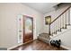 Inviting foyer with hardwood floors, staircase, and decorative front door with leaded glass at 542 Creek Stone Ln, Stone Mountain, GA 30087