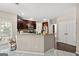 Bright kitchen with granite counters, dark cabinets, and white tiled floors at 542 Creek Stone Ln, Stone Mountain, GA 30087