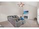 Inviting living room features a cozy fireplace, ceiling fan, and plush sectional sofa at 542 Creek Stone Ln, Stone Mountain, GA 30087