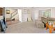 Open-concept space with plush carpeting, neutral paint, transitioning into a dining room with hardwood floors at 542 Creek Stone Ln, Stone Mountain, GA 30087