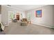 Spacious living room with plush carpeting, neutral paint, and a seamless transition to the dining area at 542 Creek Stone Ln, Stone Mountain, GA 30087