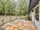View from wooden deck towards a lush backyard with mature trees, offering a private, outdoor space at 15 Laurie Ln, Covington, GA 30016