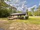 A wooden deck is featured on the back of this painted brick house, which sits on a large, grassy lot at 15 Laurie Ln, Covington, GA 30016