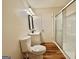 Bathroom with modern vanity, mirror, and wood look flooring and shower with sliding glass door at 15 Laurie Ln, Covington, GA 30016