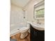 Bathroom features a shower, toilet and vanity with modern fixtures and wood look flooring at 15 Laurie Ln, Covington, GA 30016