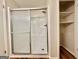 Clean bathroom showcasing a shower with sliding doors and open shelving for storage at 15 Laurie Ln, Covington, GA 30016