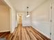 Bright dining room featuring wood flooring, beadboard accent, and modern lighting fixture near the entry at 15 Laurie Ln, Covington, GA 30016