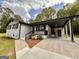 This home has a covered entrance, painted brick, well-manicured landscaping, and a long, modern driveway at 15 Laurie Ln, Covington, GA 30016