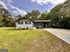 Charming one-story home with a well-maintained lawn, painted brick, and a covered carport at 15 Laurie Ln, Covington, GA 30016