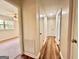 Hallway with wood flooring leads to bedrooms, each offering ample closet space for storage at 15 Laurie Ln, Covington, GA 30016