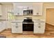 Stylish kitchen complete with stainless oven, granite counters, white cabinets and backyard views at 15 Laurie Ln, Covington, GA 30016