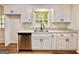 Beautiful kitchen features stainless dishwasher, granite counters and white cabinets at 15 Laurie Ln, Covington, GA 30016