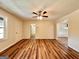 Spacious living room showcases hardwood floors, a ceiling fan and an open doorway at 15 Laurie Ln, Covington, GA 30016