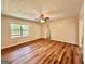 Inviting living room featuring wood floors, ceiling fan, and natural light from the large window at 15 Laurie Ln, Covington, GA 30016