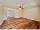 Spacious living room featuring wood-look floors, neutral walls, ceiling fan and bright entryway at 15 Laurie Ln, Covington, GA 30016