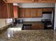 The kitchen features granite countertops, wood cabinets, and stainless steel appliances at 3209 Abbeywood Dr, Decatur, GA 30034