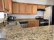 Kitchen with granite countertops, wood cabinets, stainless steel appliances, and a stainless steel sink at 3209 Abbeywood Dr, Decatur, GA 30034