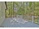 Wide shot of the backyard deck with white railing and a view of the wooded area at 110 Greenridge Ct, Fayetteville, GA 30215