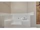 Large white corner bathtub next to a shower with decorative tile in a well-lit bathroom at 110 Greenridge Ct, Fayetteville, GA 30215